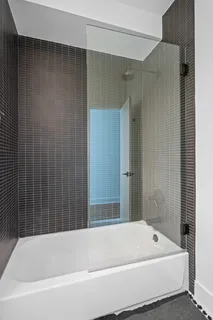 a bathroom with a bathtub and shower