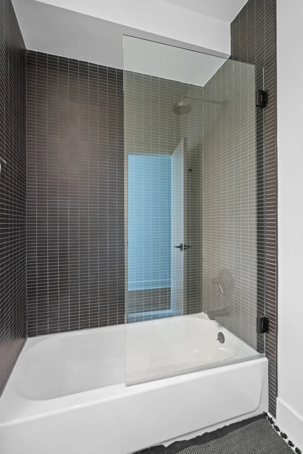 a bathroom with a bathtub and shower