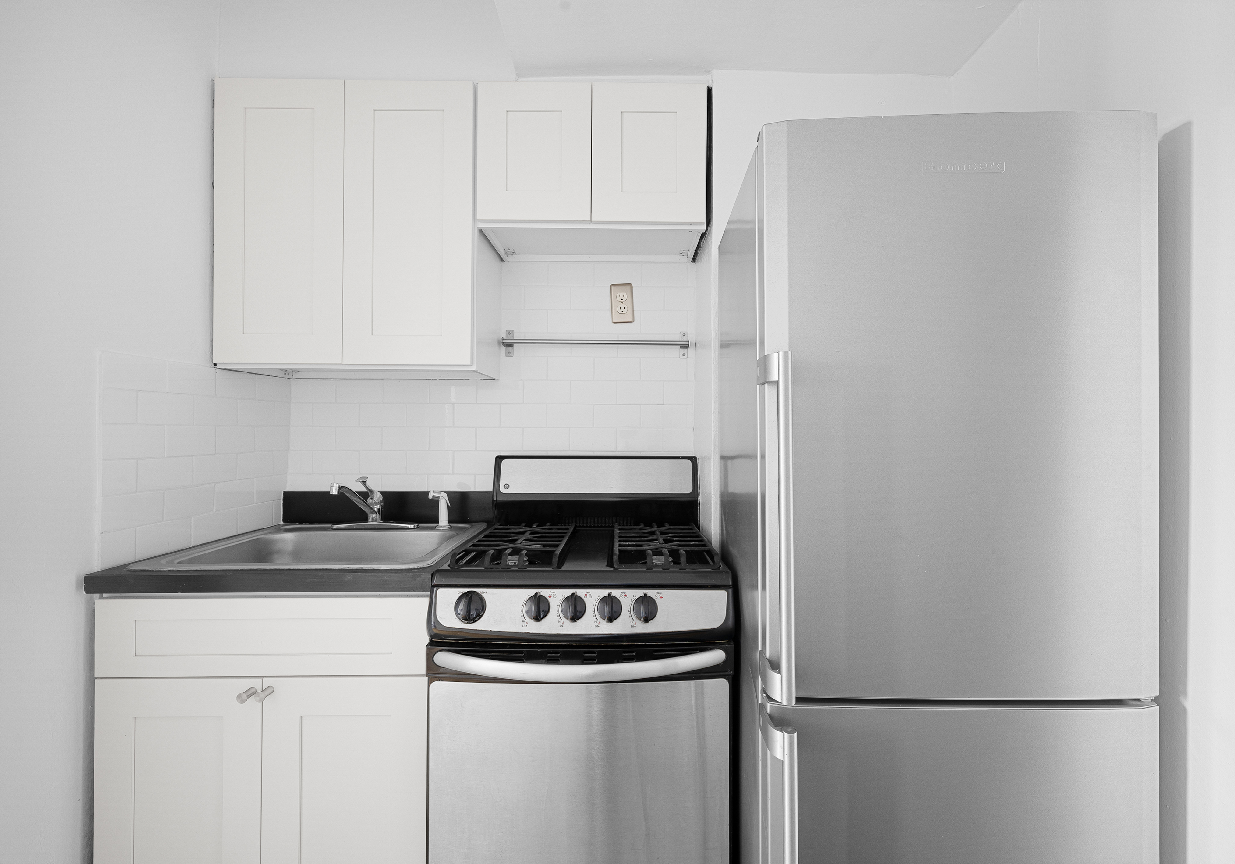 50-21 39th Place, Unit 6D Queens, NY 11104 - Photo 6 of 15 a kitchen with stainless steel appliances granite countertop a refrigerator a stove a sink and white cabinets