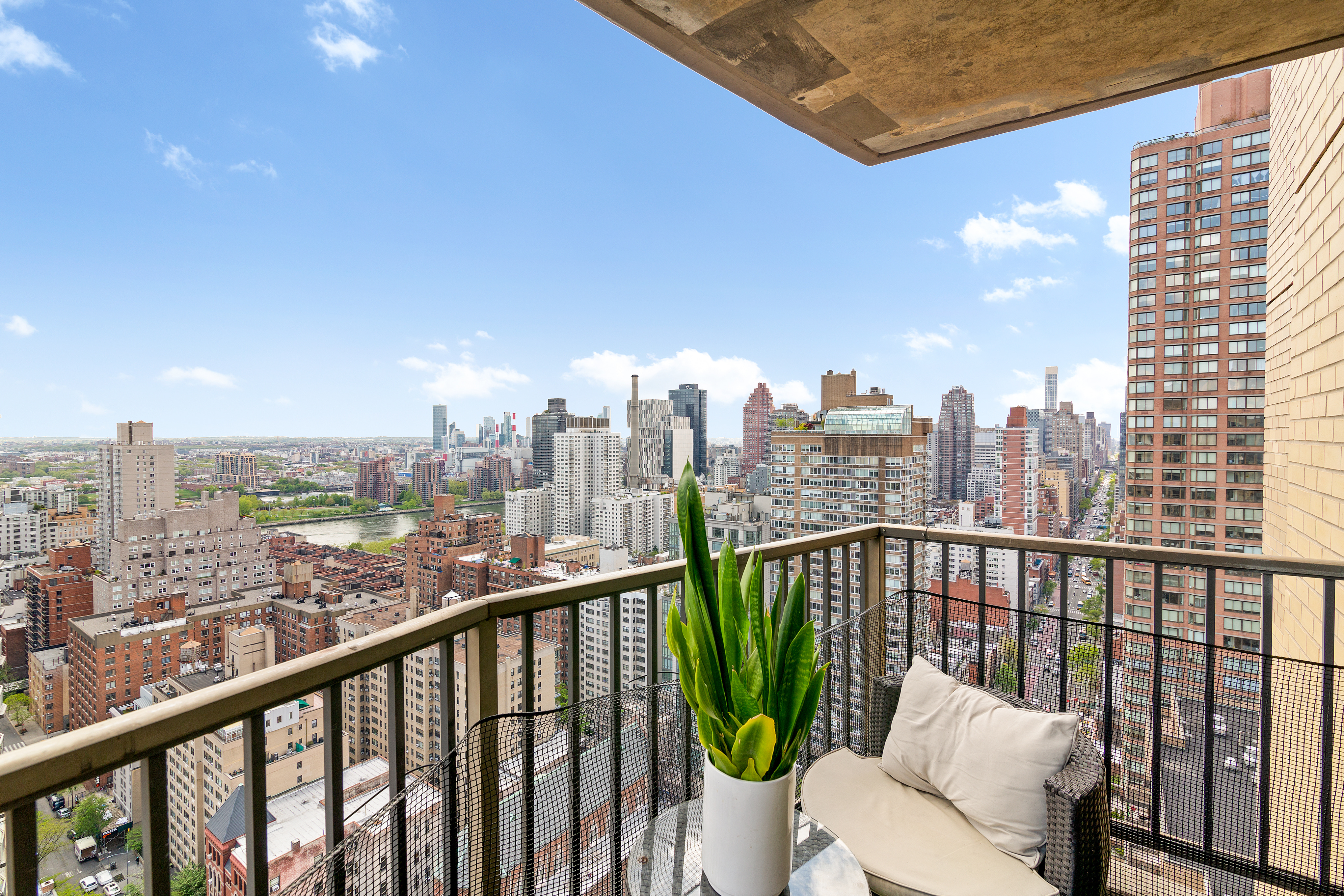 345 East 80th Street, Unit 32F Manhattan, NY 10075 - Photo 2 of 9 a view of a city view from a roof deck with sitting area