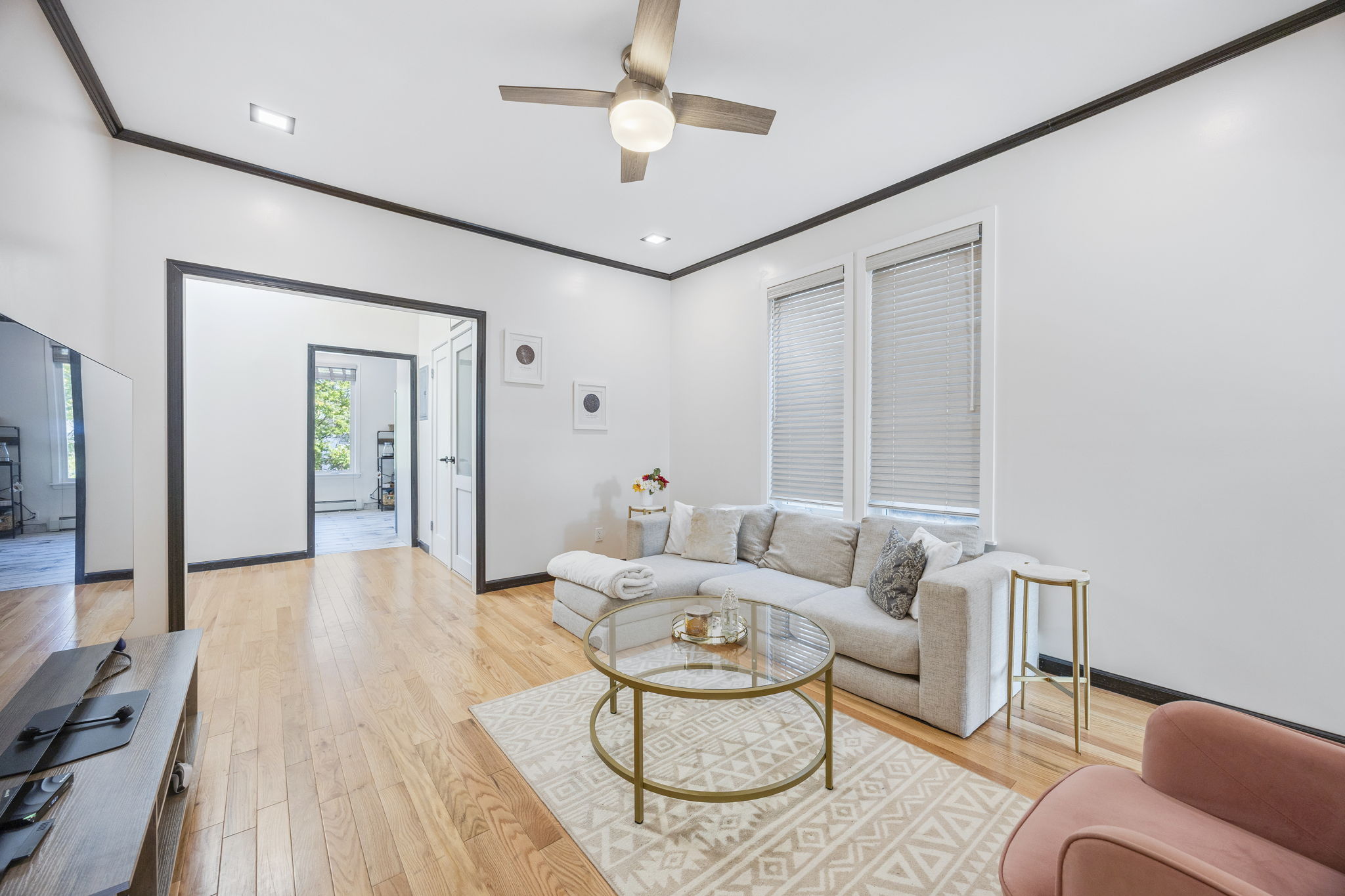 25-69 46th Street, Unit 2 Queens, NY 11103 - Photo 10 of 13 a living room with furniture and a chandelier