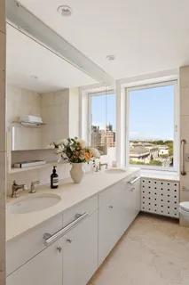 a bathroom with a sink double vanity and a window