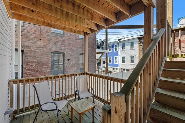 a view of staircase with railing and white walls