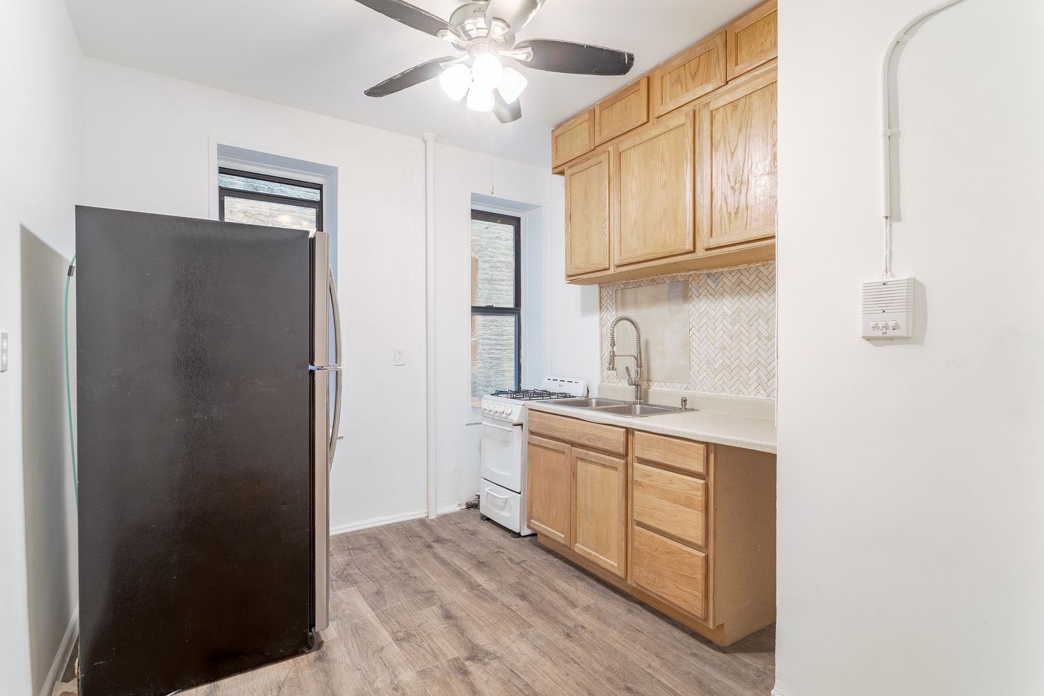 a kitchen with stainless steel appliances granite countertop a refrigerator and a sink