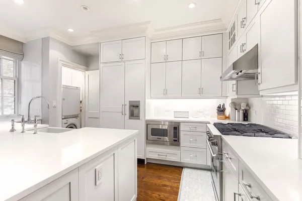 a kitchen with a sink stove and cabinets