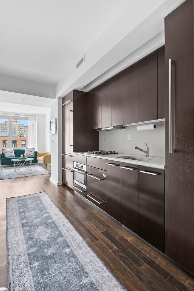 a view of a kitchen with kitchen island and stainless steel appliances