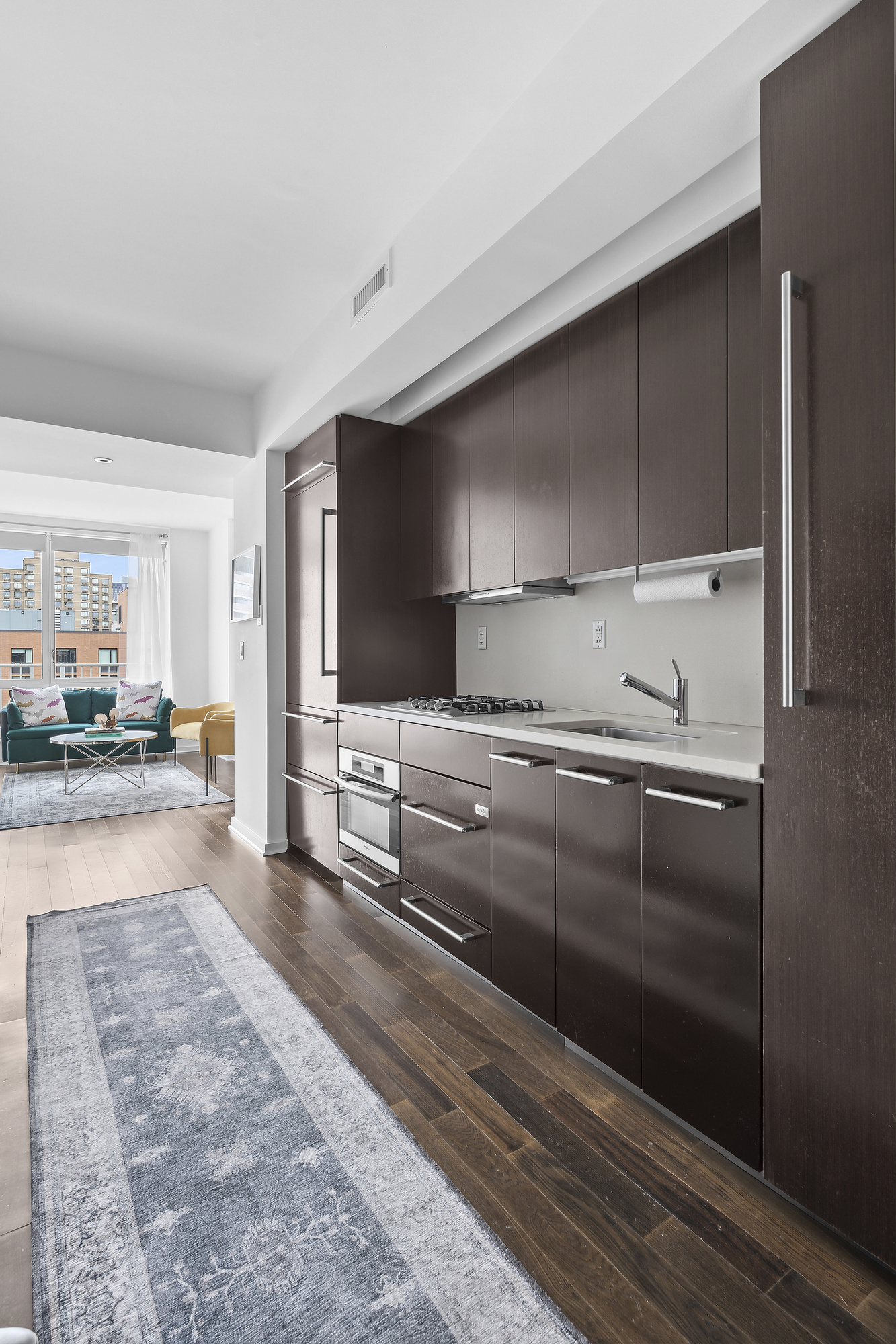 340 East 23rd Street, Unit 15G Manhattan, NY 10010 - Photo 4 of 9 a view of a kitchen with kitchen island and stainless steel appliances