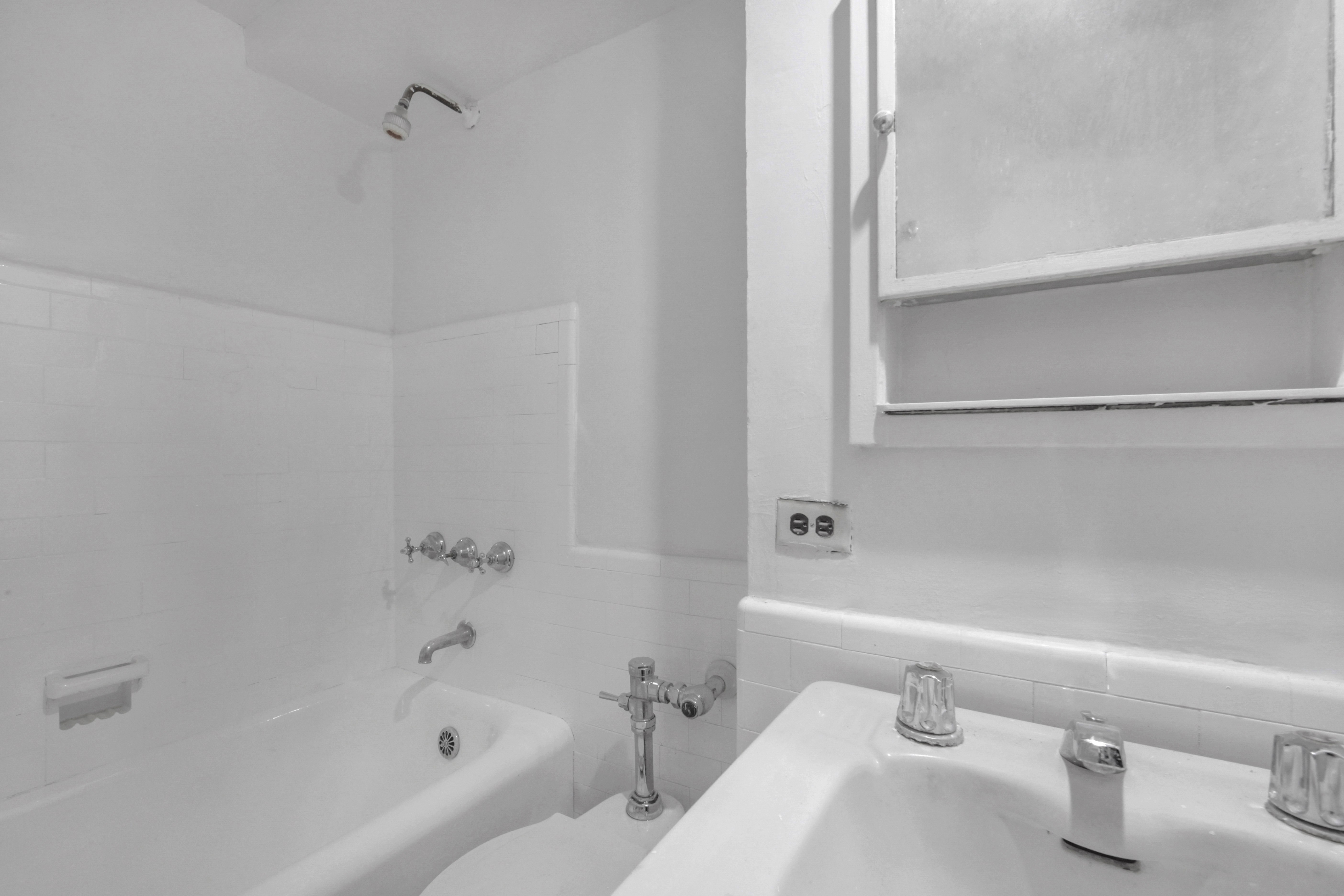 320 East 42nd Street, Unit 418 Manhattan, NY 10017 - Photo 7 of 10 a bathroom with a sink and a bathtub