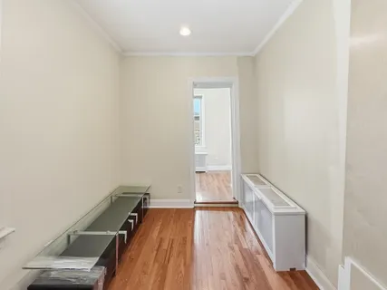 a view of a hallway with wooden floor
