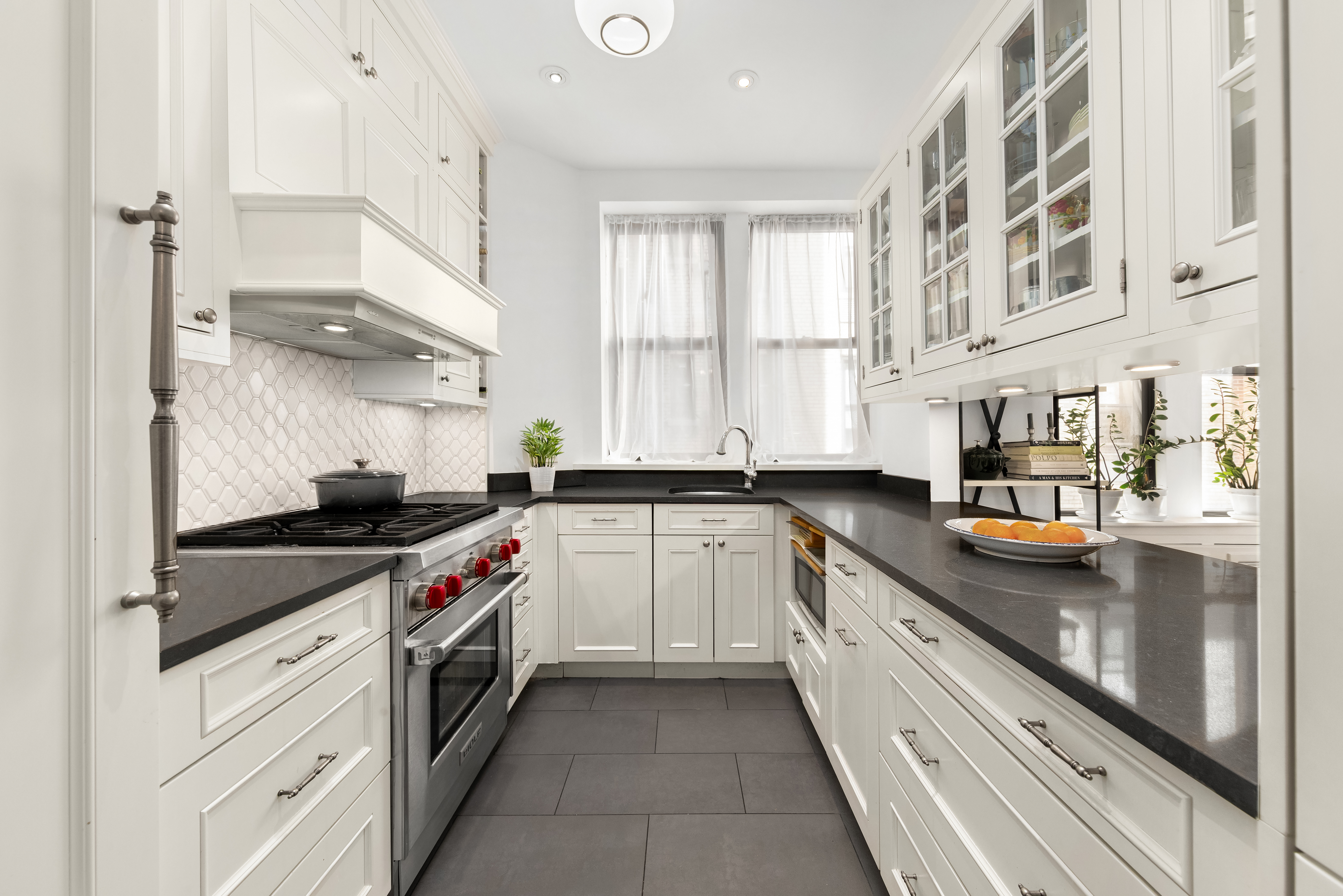 929 Park Avenue, Unit 6C Manhattan, NY 10028 - Photo 2 of 10 a kitchen with stainless steel appliances granite countertop a stove and a sink
