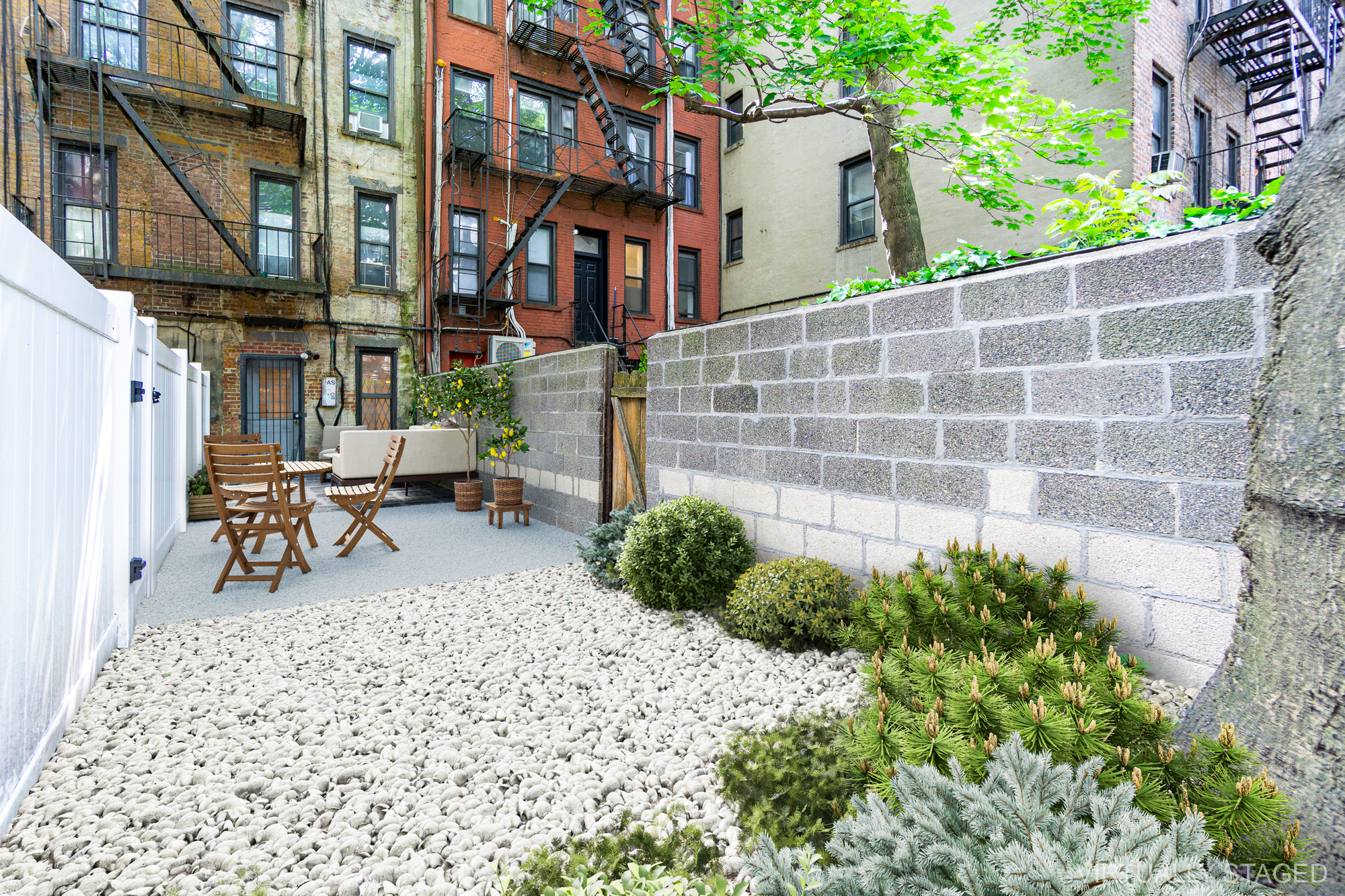 319 East 5th Street, Unit B Manhattan, NY 10003 - Photo 3 of 17 a view of a patio with table and chairs and potted plants