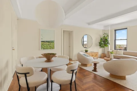 a living room with furniture a mirror and a table