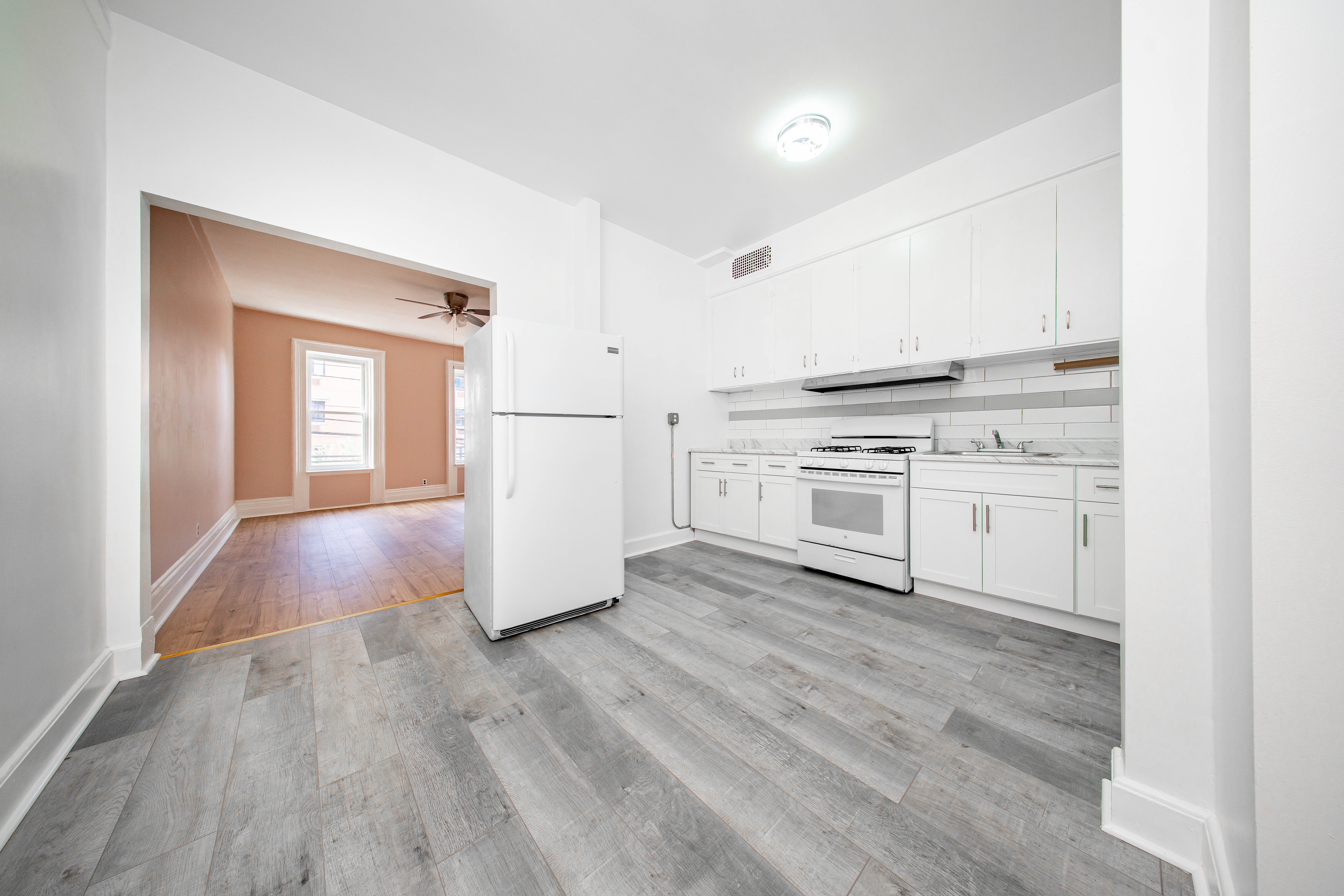 22-17 Astoria Boulevard, Unit 2W Queens, NY 11102 - Photo 5 of 10 a kitchen with a stove top oven and cabinets