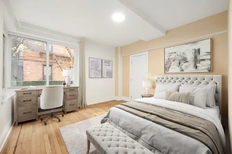 a spacious bedroom with a bed and glass door