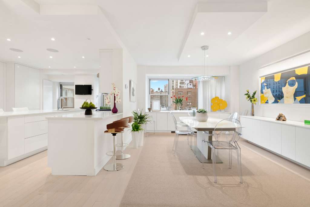 150 East 69th Street, Unit 7K Manhattan, NY 10021 - Photo 3 of 22 a living room with furniture and a table with potted plants