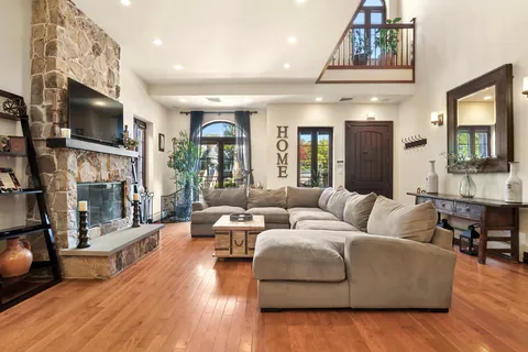 a living room with fireplace furniture and a flat screen tv