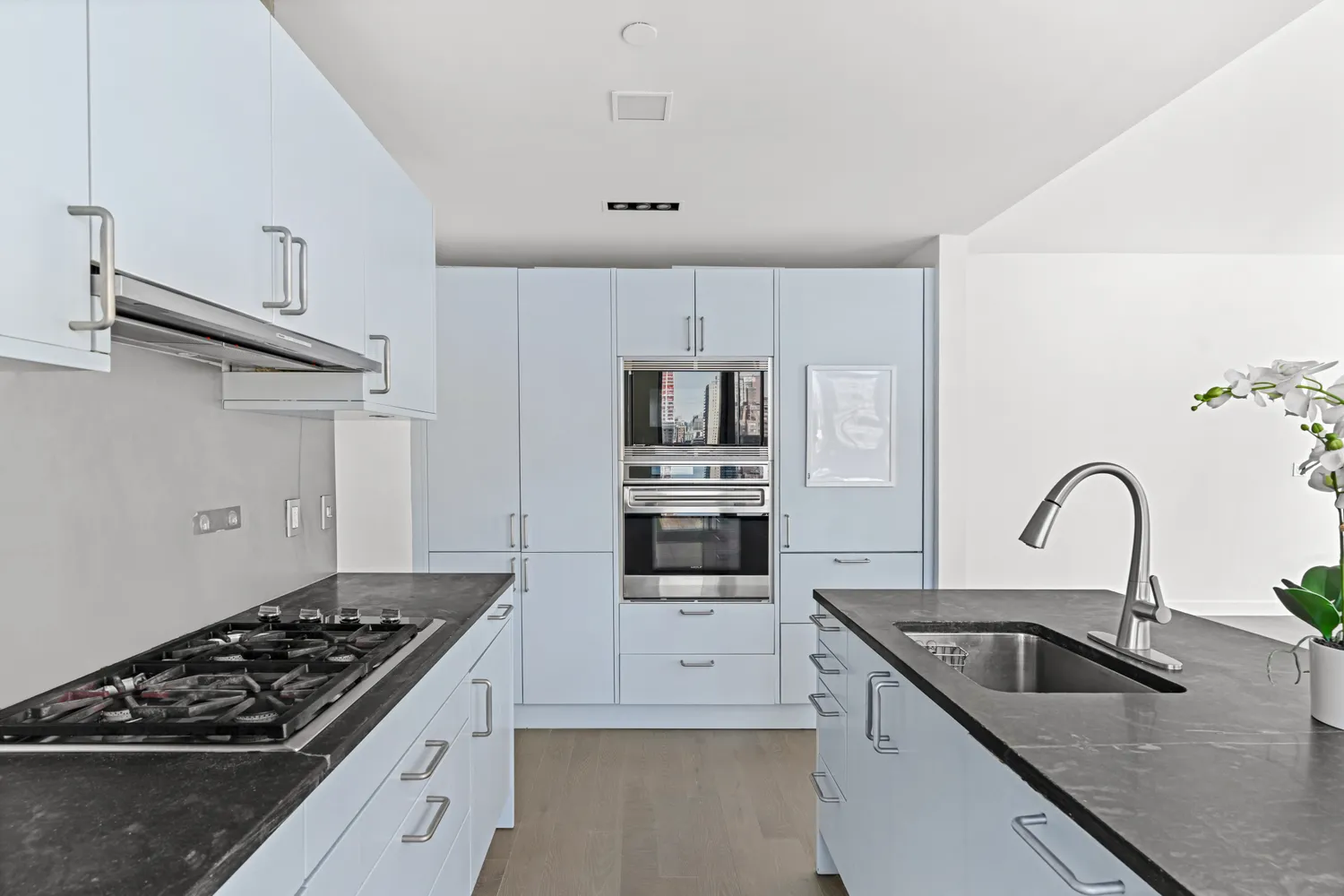 a kitchen with stainless steel appliances granite countertop a sink stove and refrigerator
