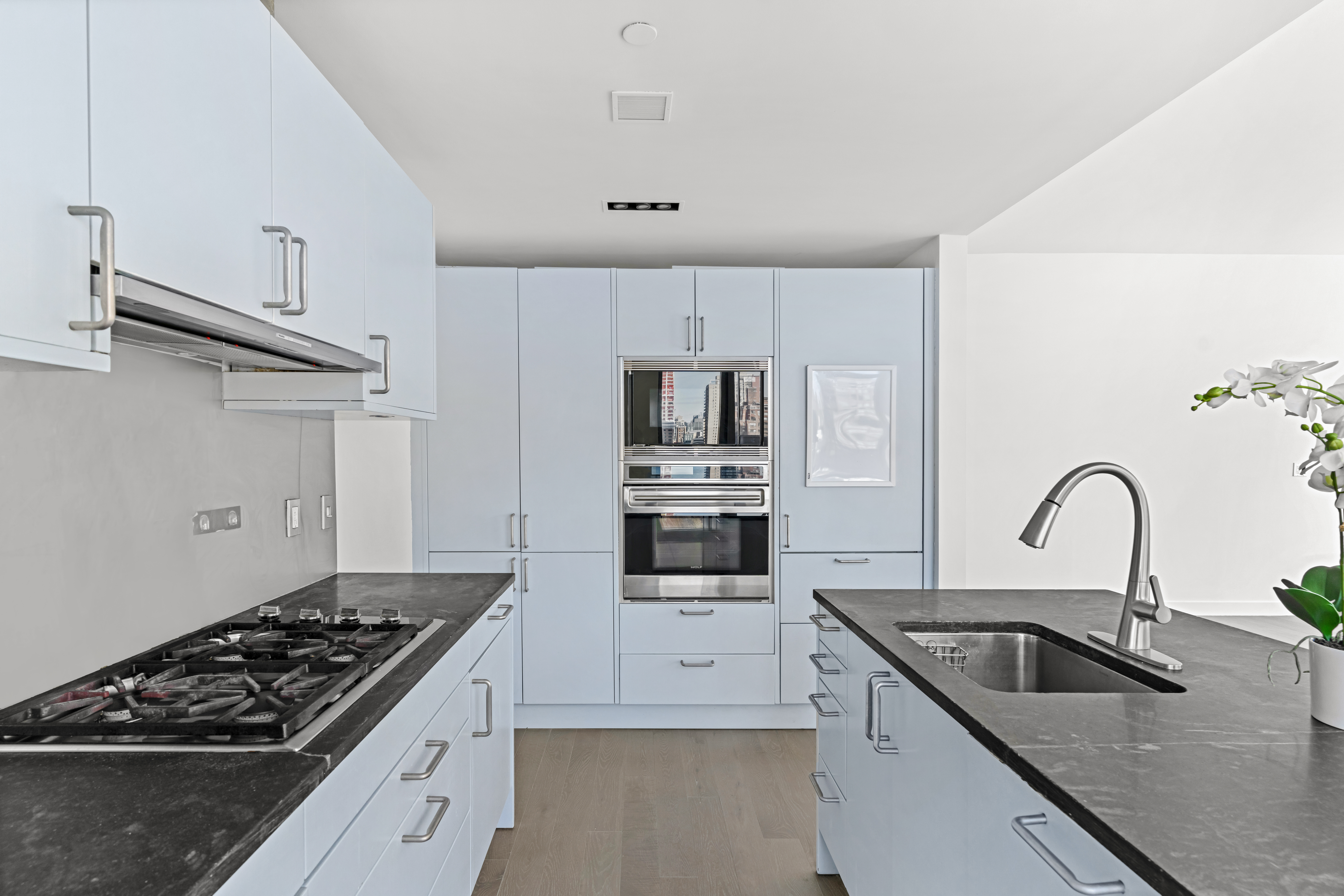 450 East 83rd Street, Unit 9E Manhattan, NY 10028 - Photo 5 of 18 a kitchen with stainless steel appliances granite countertop a sink stove and refrigerator