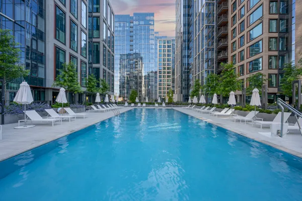 a swimming pool with outdoor seating and yard