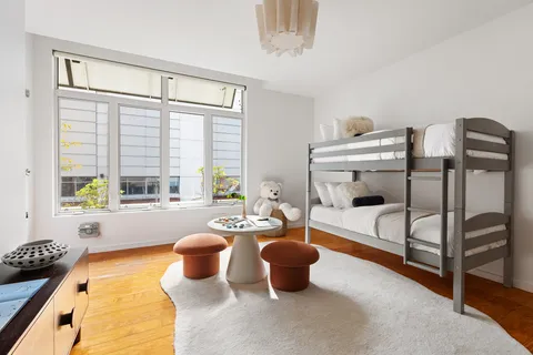 a dining room with furniture and a window