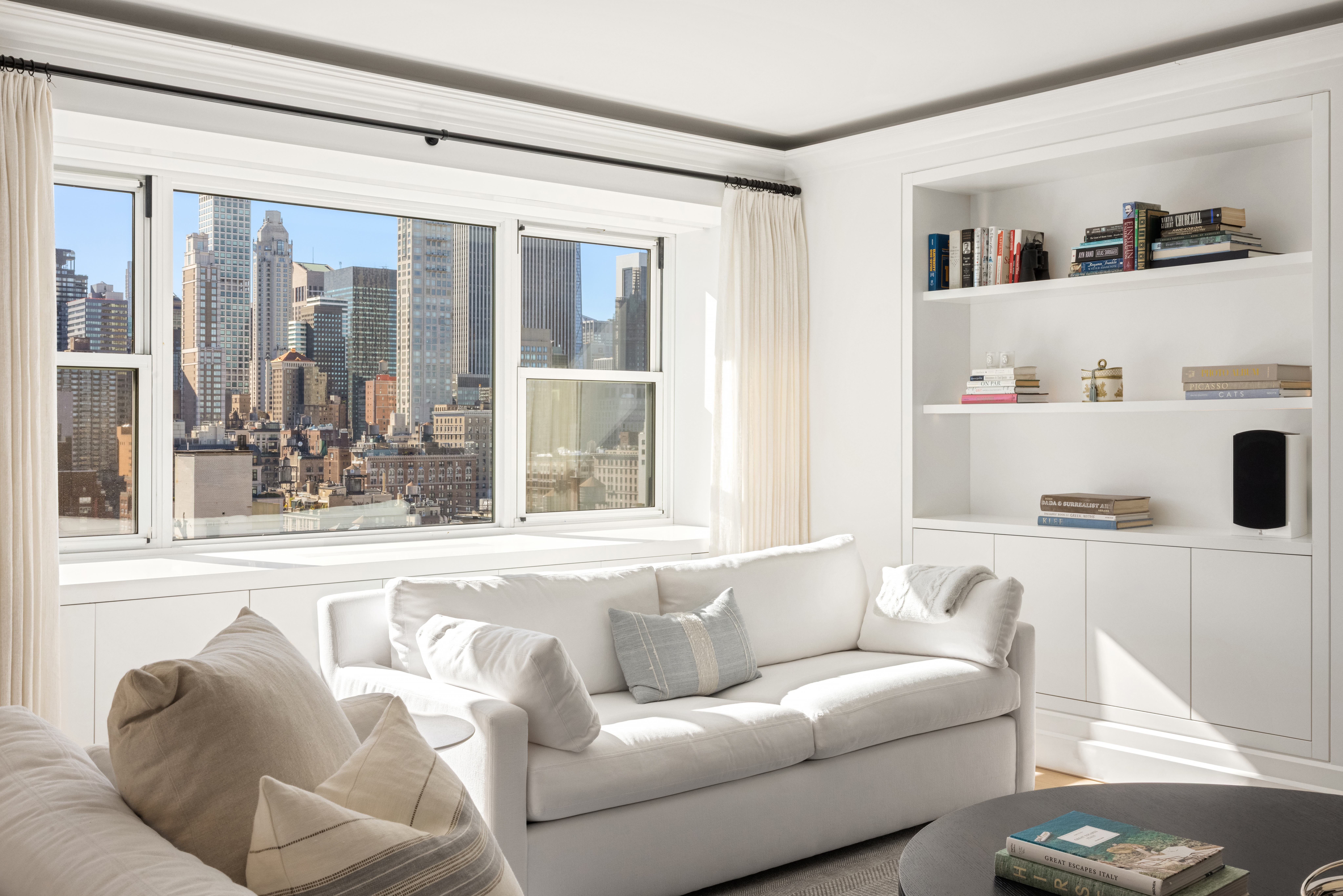 150 East 69th Street, Unit 18S Manhattan, NY 10021 - Photo 2 of 16 a living room with furniture and a window