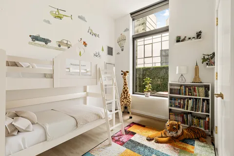 a bedroom with a bed furniture and a window