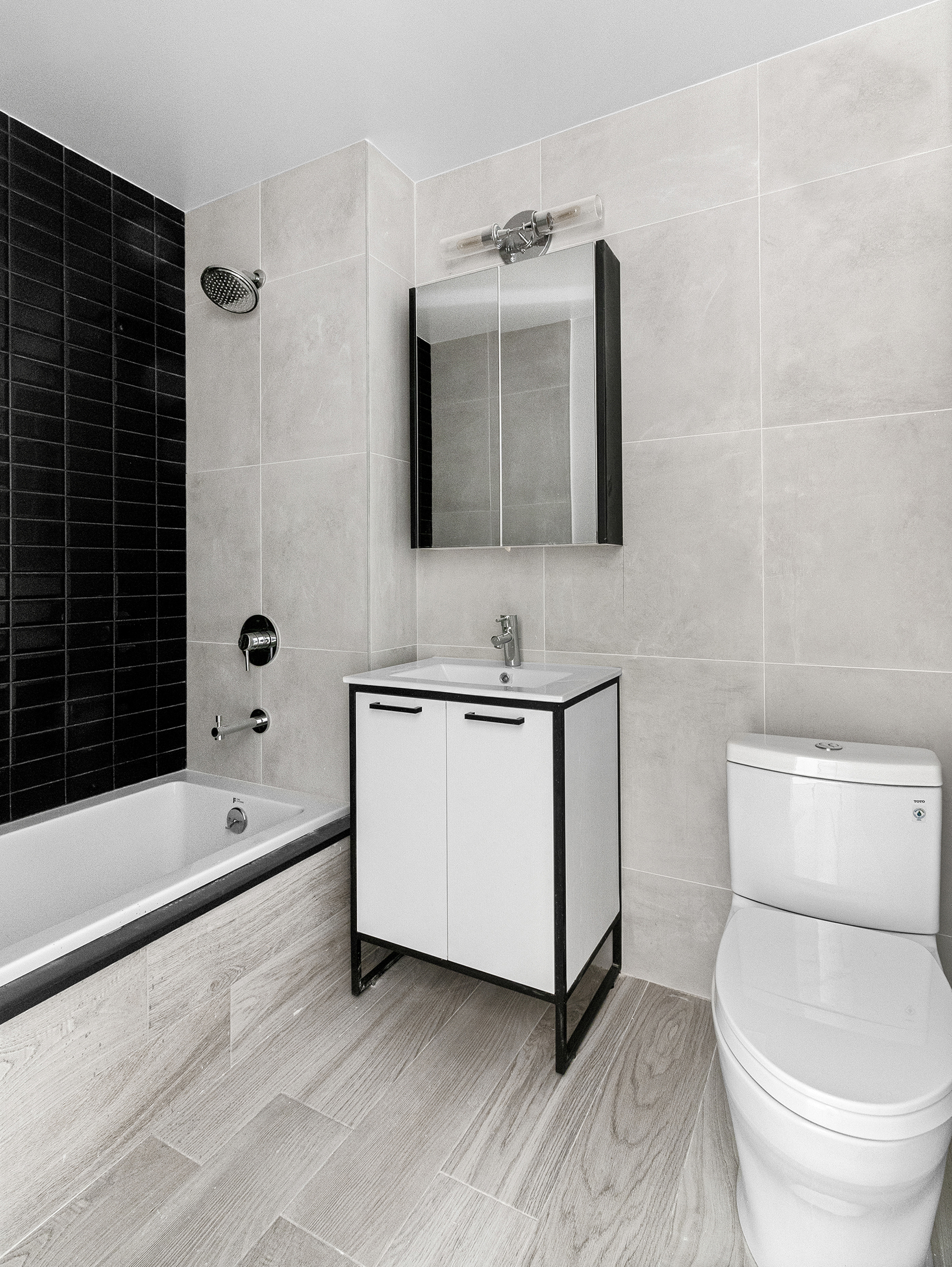 1098 Madison Street, Unit 4B Brooklyn, NY 11221 - Photo 9 of 11 a bathroom with a sink a toilet and shower