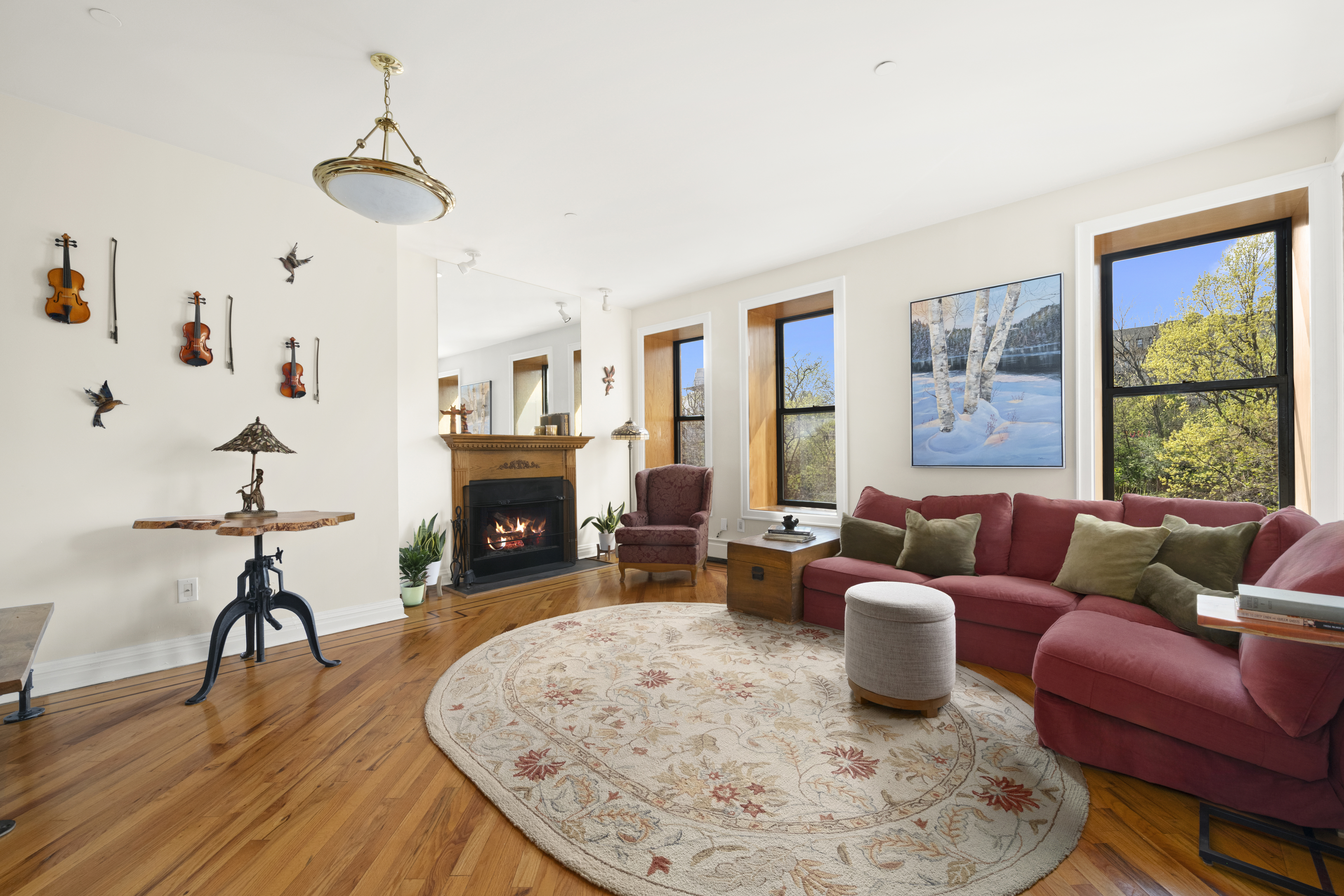 370 St Nicholas Avenue, Unit PH5B Manhattan, NY 10027 - Photo 2 of 12 a living room with furniture and a fireplace