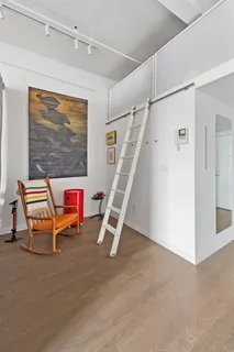 a room with wooden floor and white walls