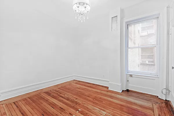 50 East 96th Street, Unit 2A Manhattan, NY 10128 - Photo 5 of 7 a bedroom with a bed and a window