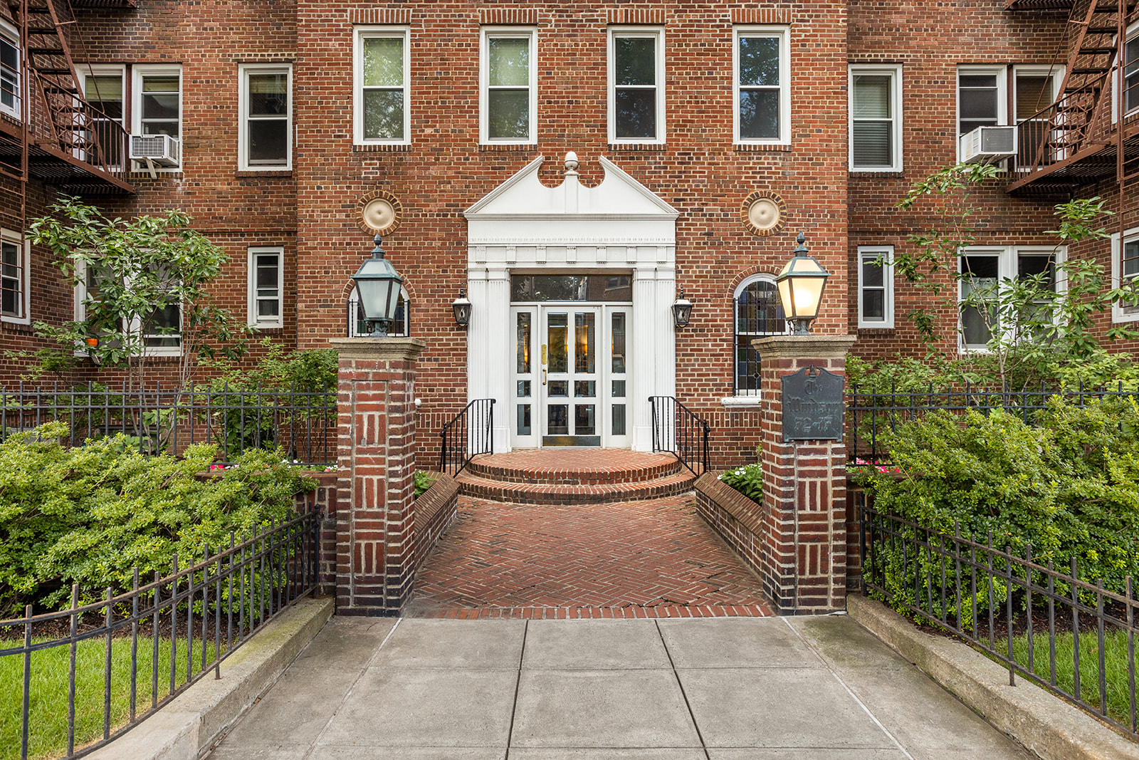 72-17 34th Avenue, Unit 4J Queens, NY 11372 - Photo 10 of 14 a front view of a house with a garden