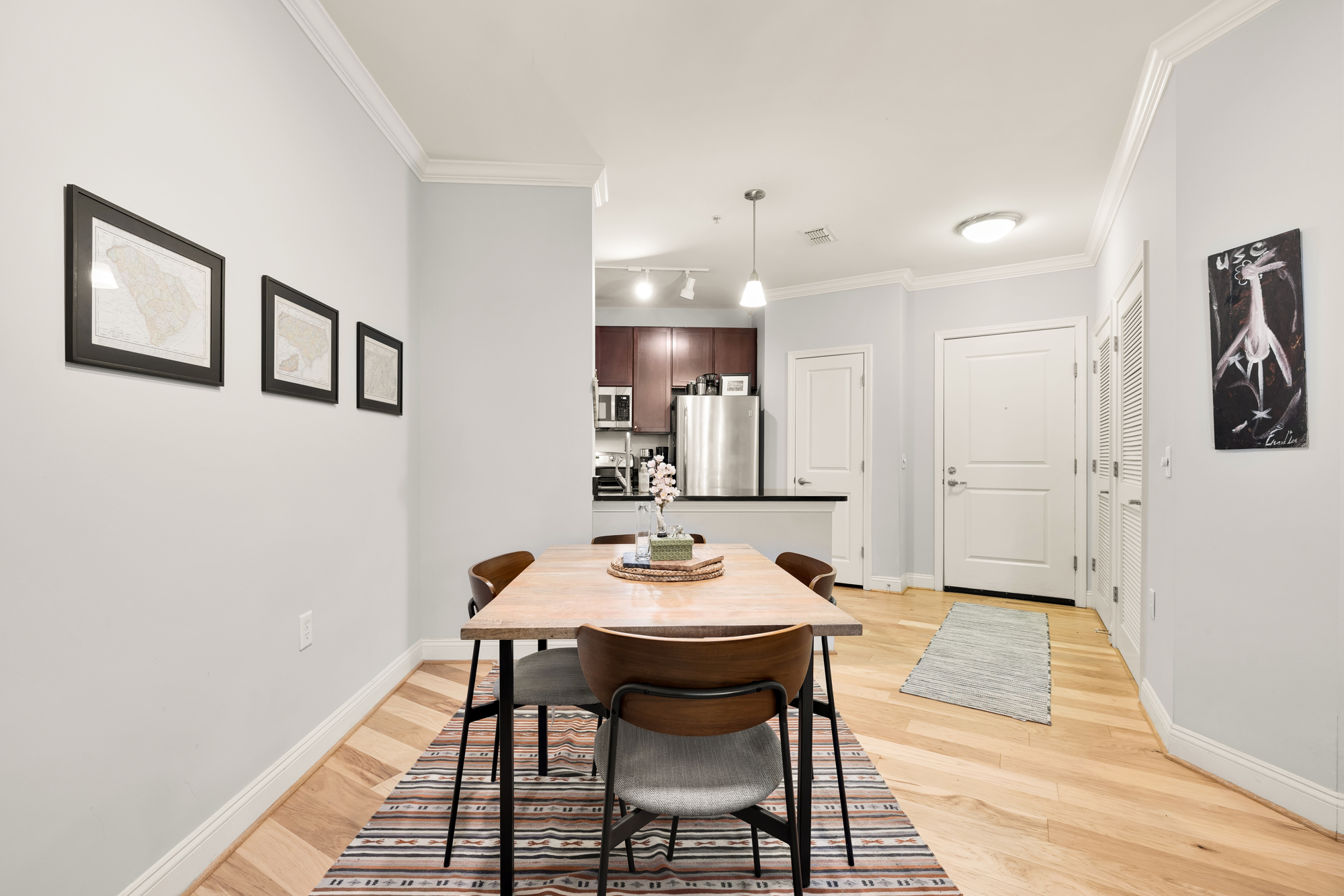 1391 Pennsylvania Ave. Southeast, Unit 324 Washington, DC 20003 - Photo 7 of 33 a view of a dining room with furniture and wooden floor