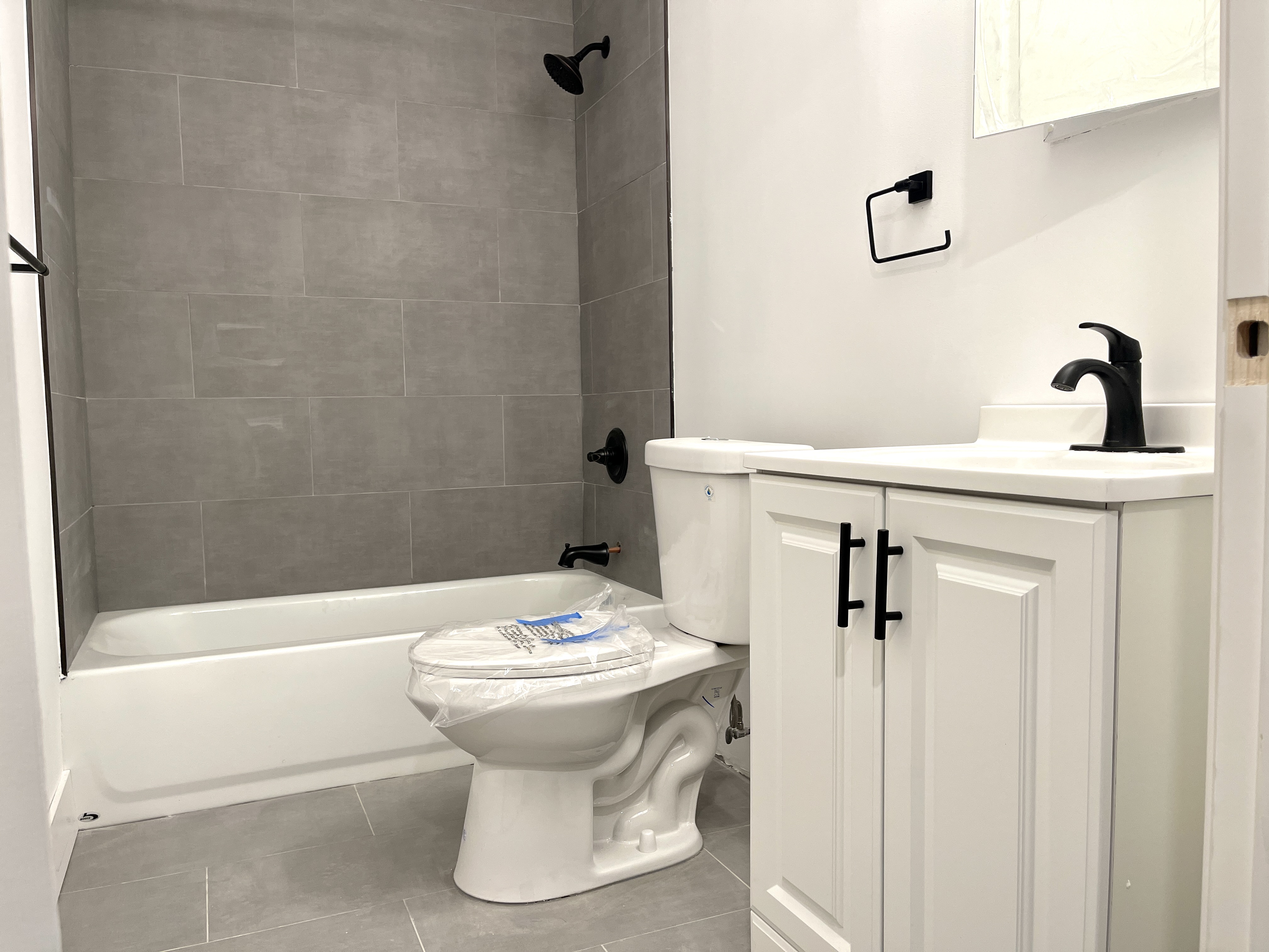 1999 3rd Avenue, Unit 1 Manhattan, NY 10029 - Photo 17 of 23 a bathroom with a sink and mirror
