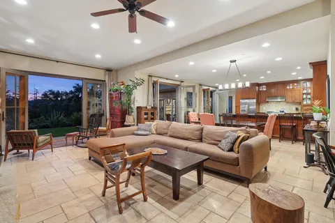 a living room with furniture and kitchen view