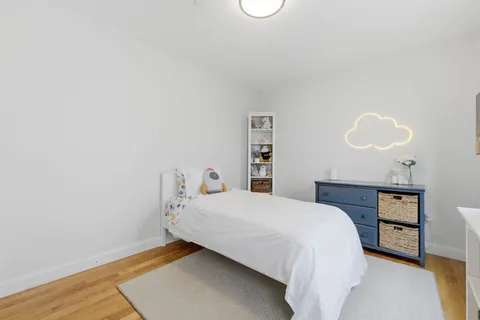 a bedroom with a bed and a night stand