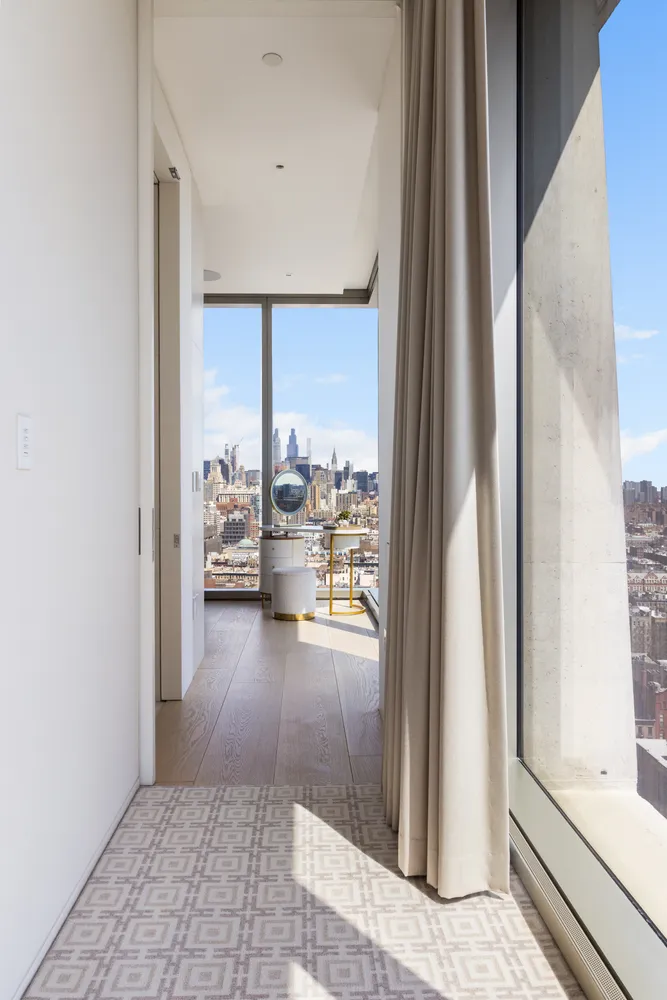 a dining room with furniture and a potted plant