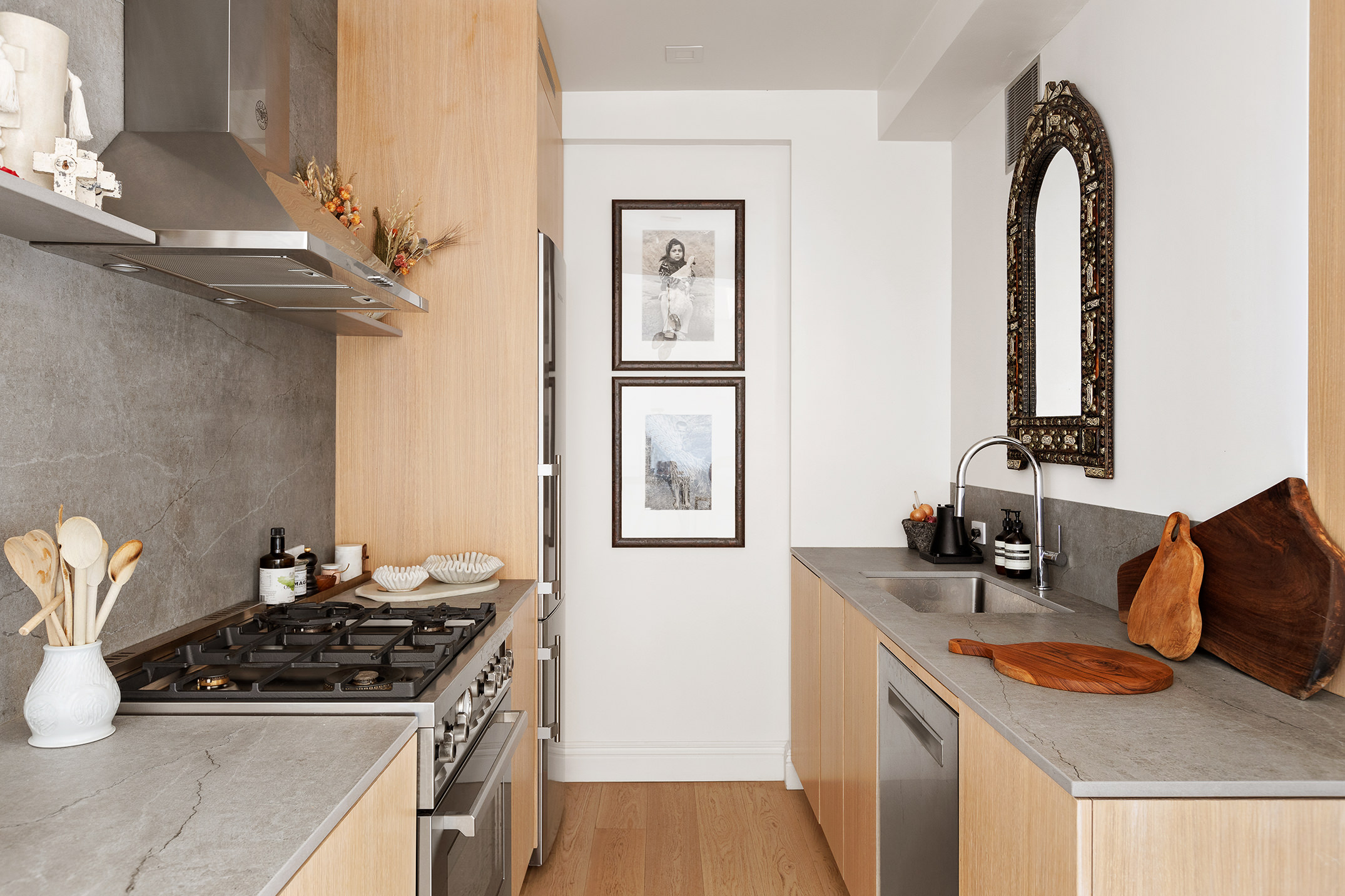 30 5th Avenue, Unit 16H Manhattan, NY 10011 - Photo 7 of 15 a kitchen with stainless steel appliances granite countertop a sink stove and refrigerator