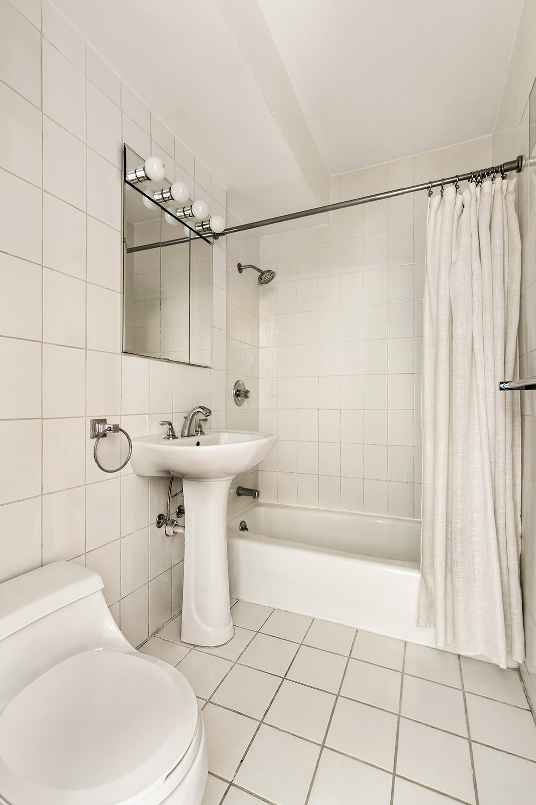 240 East 46th Street, Unit 7G Manhattan, NY 10017 - Photo 11 of 14 a bathroom with a sink toilet and shower