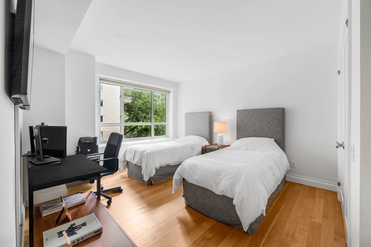 a bedroom with two beds and a window