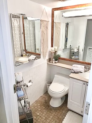 162 Christopher Street, Unit TH4 Manhattan, NY 10014 - Photo 4 of 5 a bathroom with a toilet sink and mirror