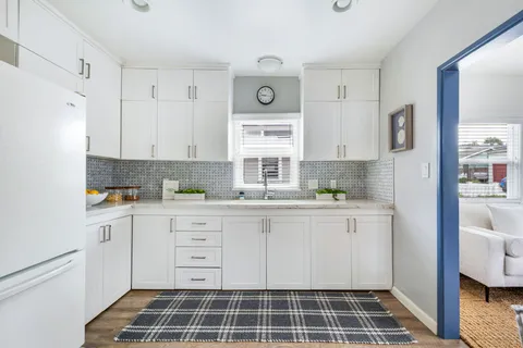 a kitchen with stainless steel appliances a stove a sink and a refrigerator