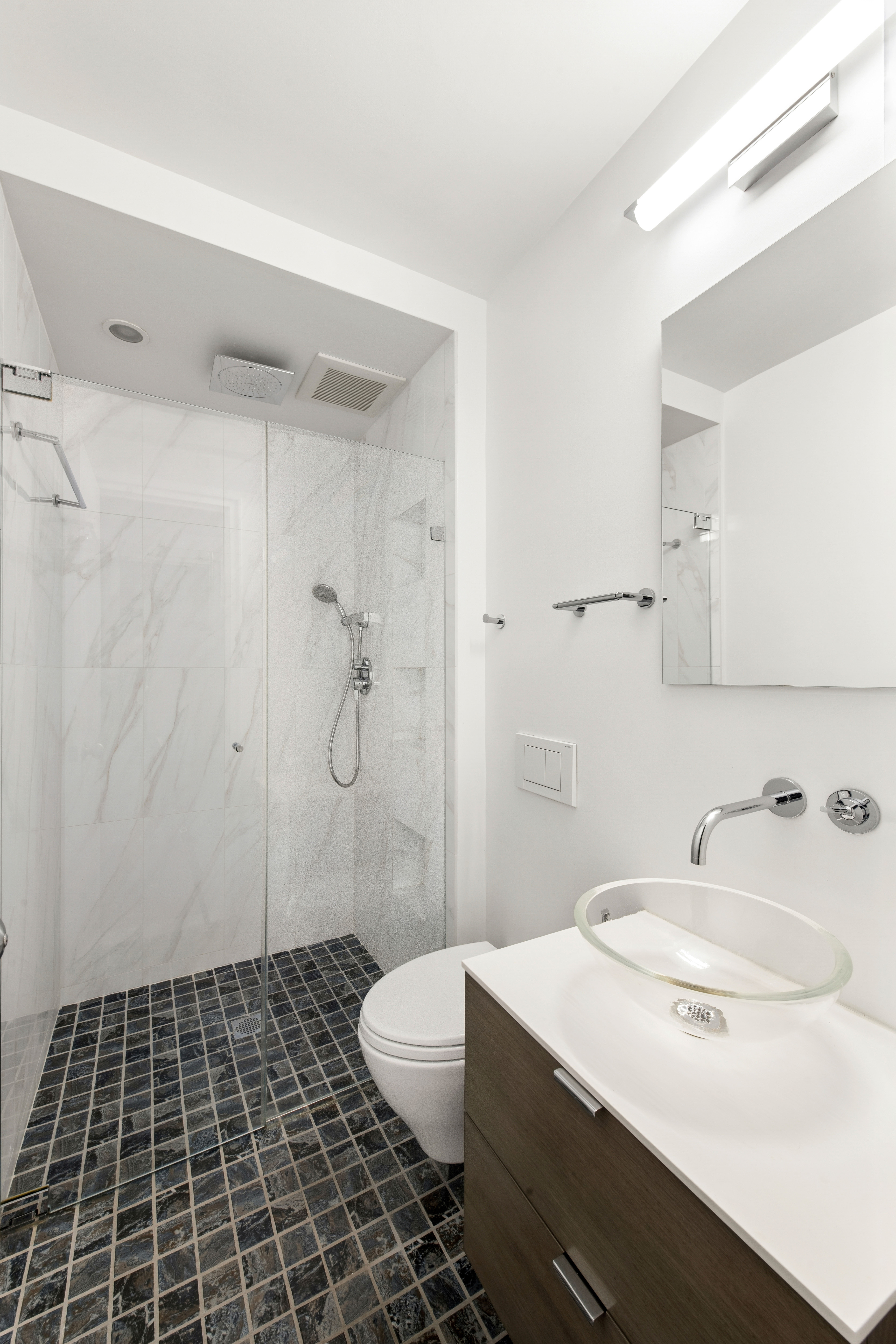 860 5th Avenue, Unit 3H Manhattan, NY 10065 - Photo 11 of 17 a bathroom with a sink a toilet and shower