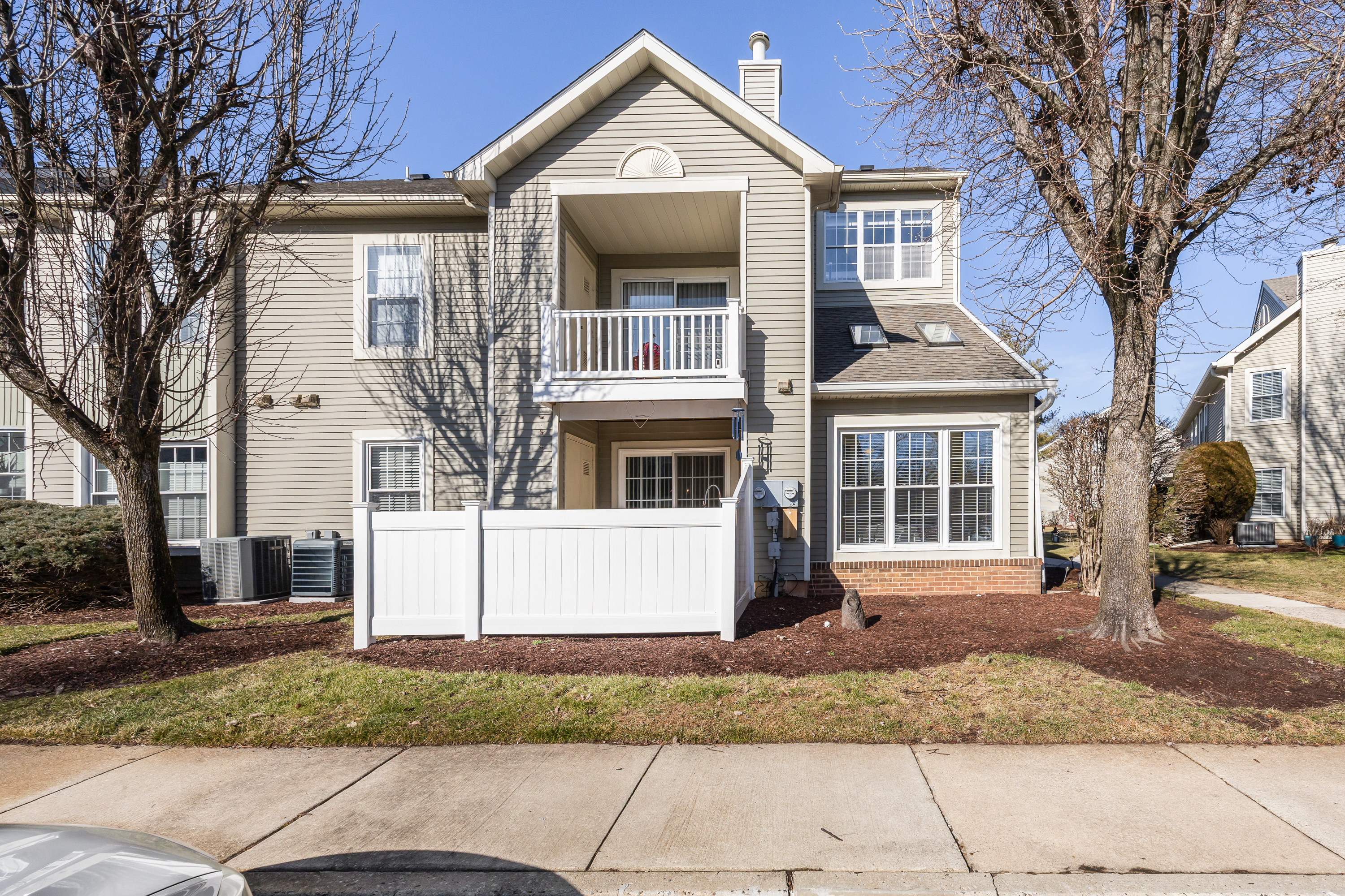 1007 A Yarmouth Lane Mount Laurel, NJ 08054 - Photo 25 of 27 a front view of a house with a yard and trees