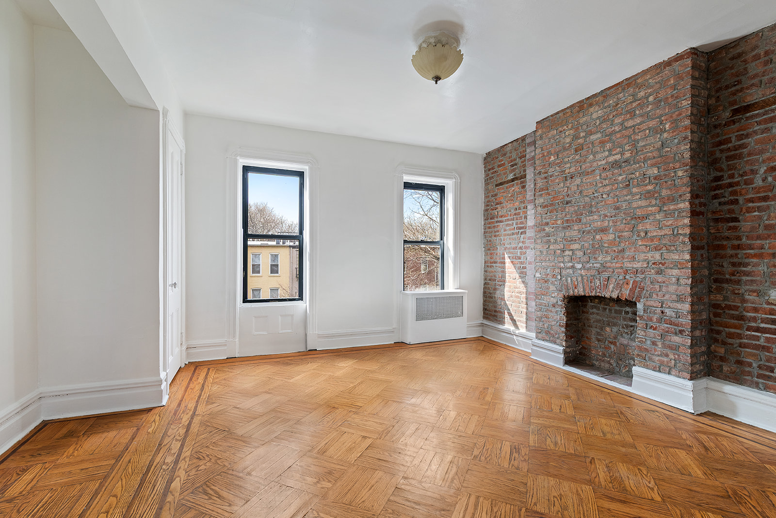 156 Bainbridge Street Brooklyn, NY 11233 - Photo 9 of 14 a bedroom with a bed and a fireplace
