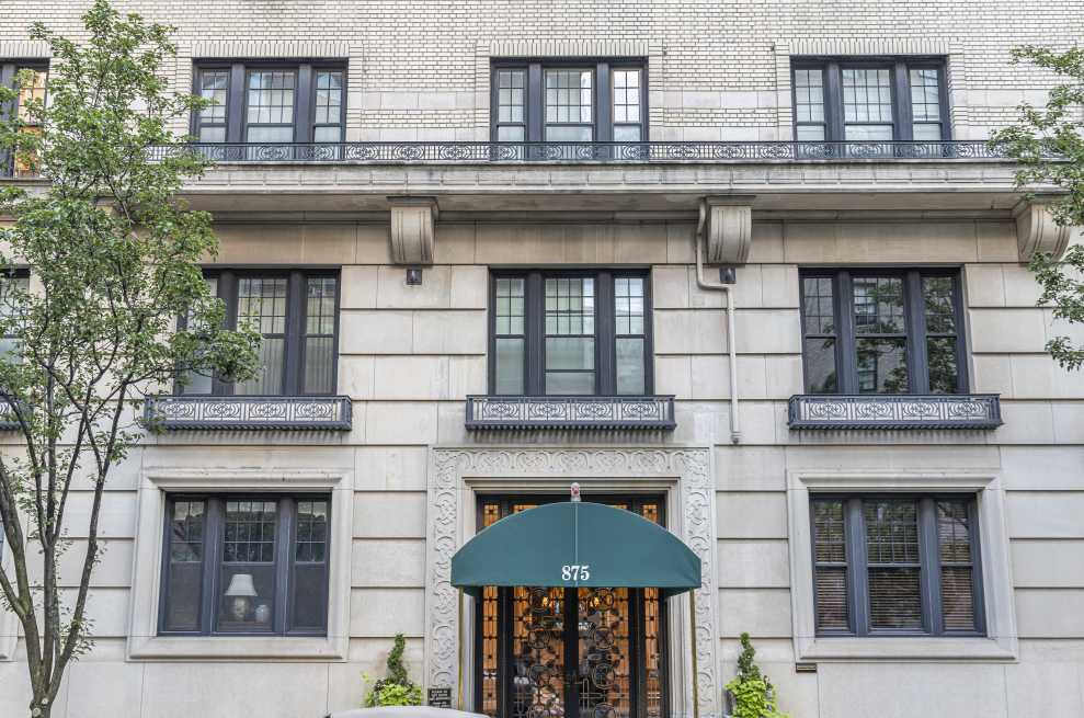 875 Park Avenue, Unit 11C Manhattan, NY 10075 - Photo 23 of 25 a front view of a house with large windows and a table and chairs