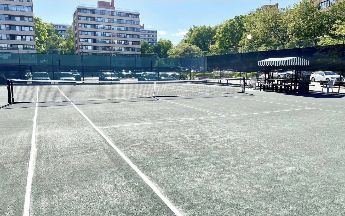 11-01 162nd Street, Unit 3D Queens, NY 11357 - Photo 14 of 16 a view of a tennis ground with large trees