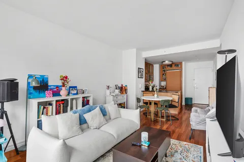 a living room with furniture and a wooden floor