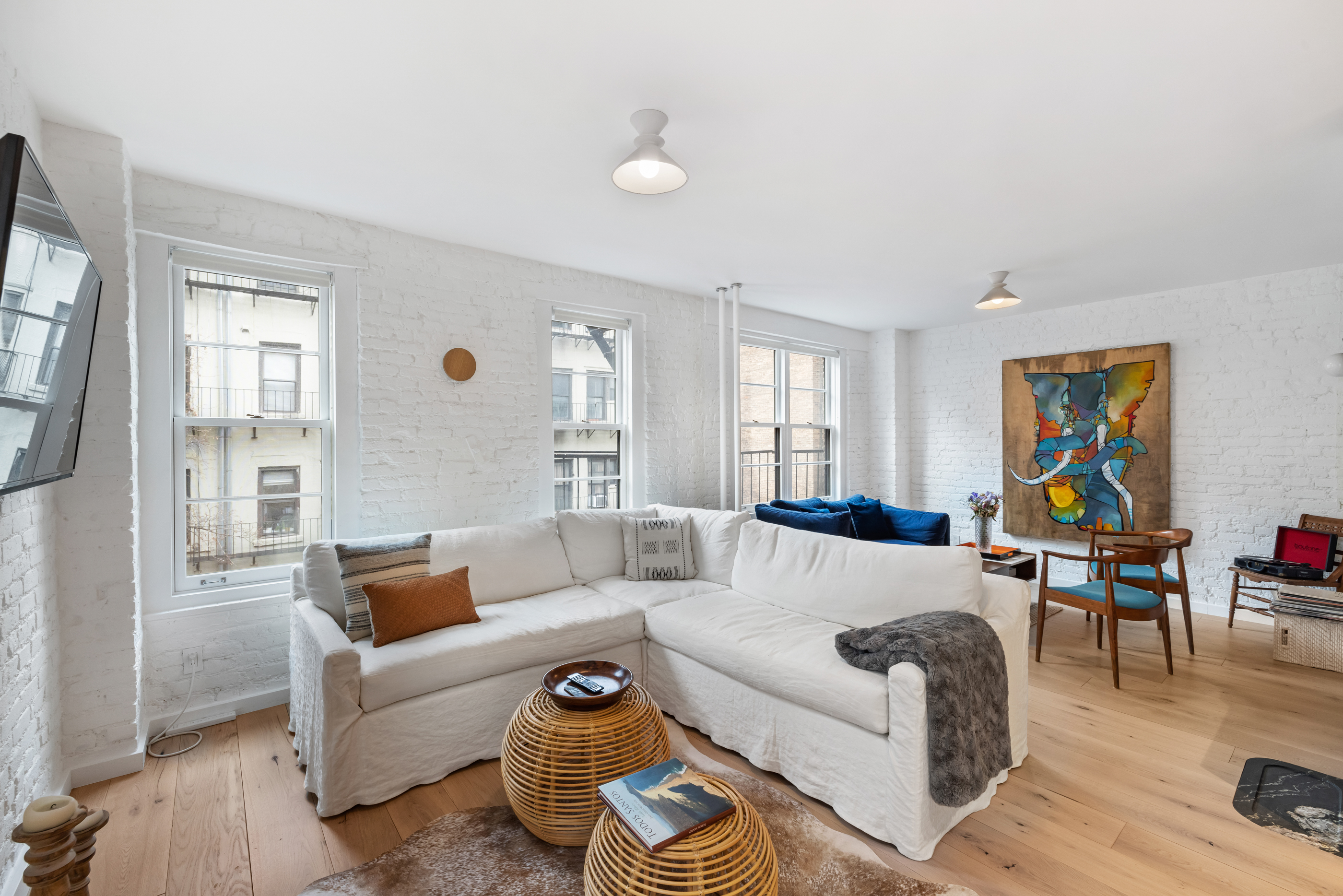 57 Thompson Street, Unit 4E Manhattan, NY 10012 - Photo 8 of 16 a living room with furniture and a window