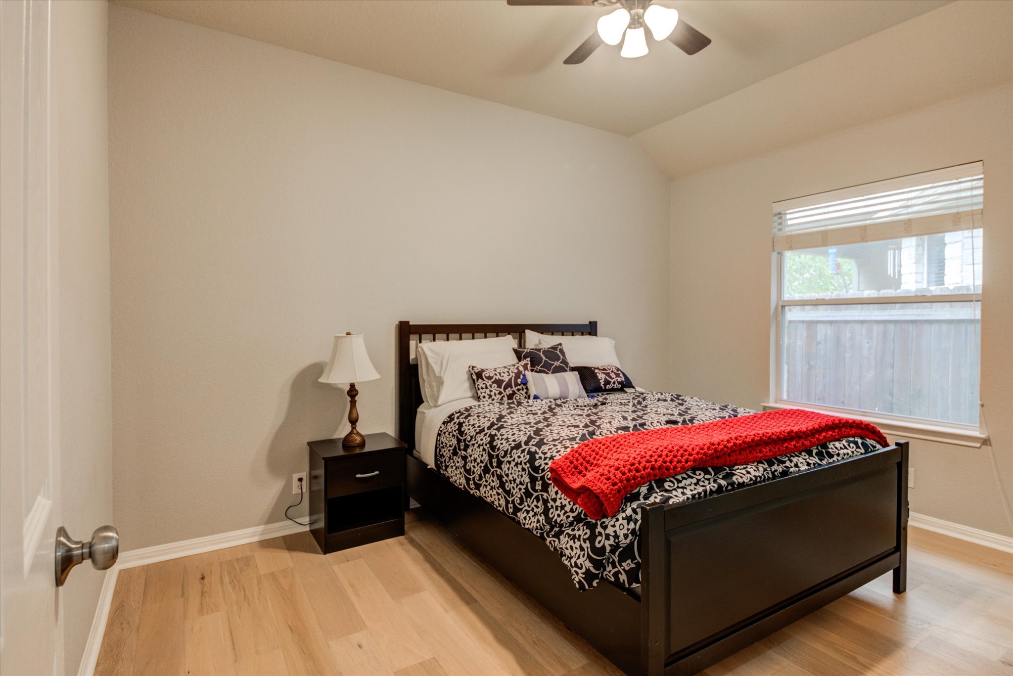 5412 Batak Lane Austin, TX 78749 - Photo 17 of 40 a bed sitting in a bedroom next to a window and a chandelier