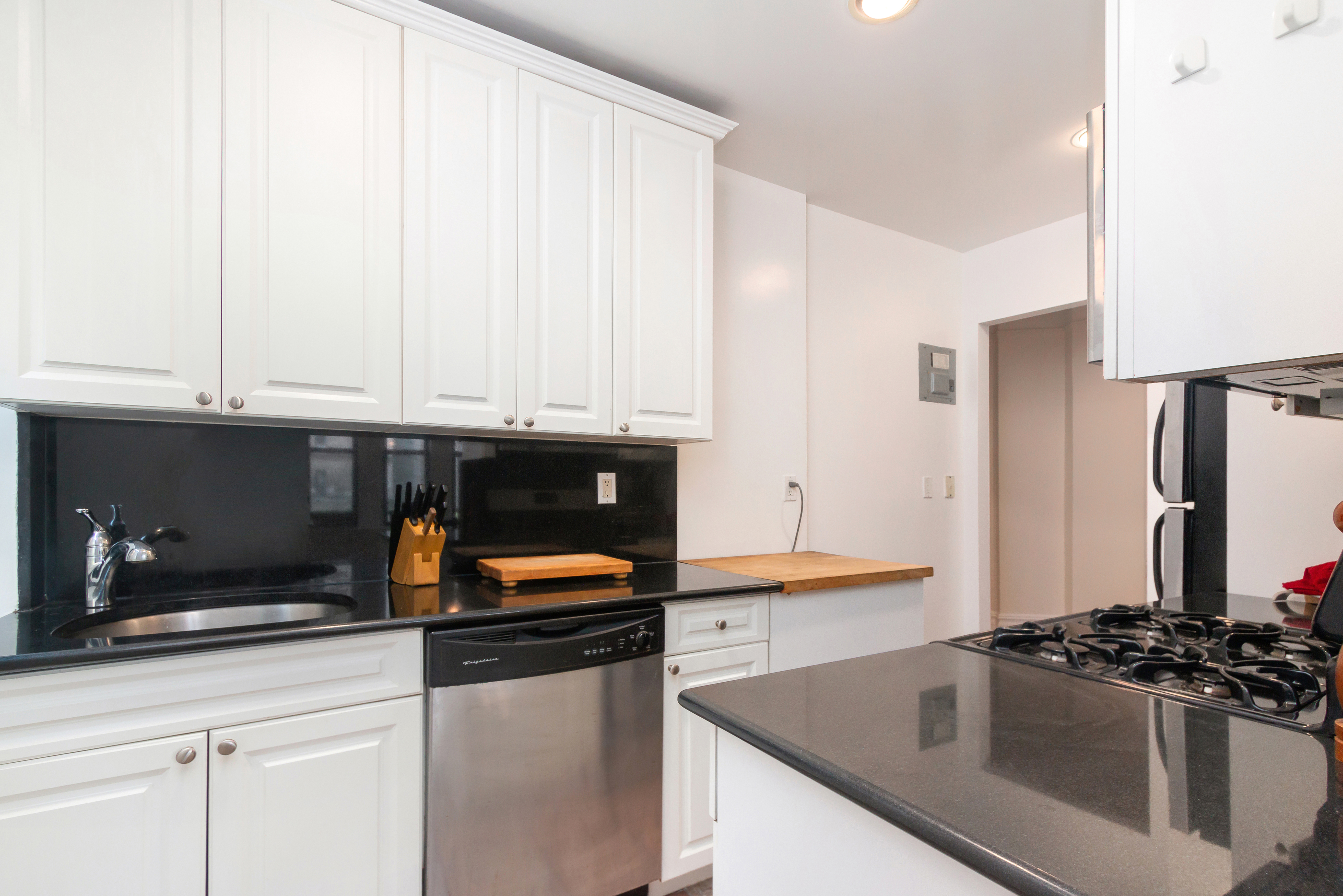 801 Riverside Drive, Unit 4F Manhattan, NY 10032 - Photo 9 of 13 a kitchen with stainless steel appliances a sink and a stove